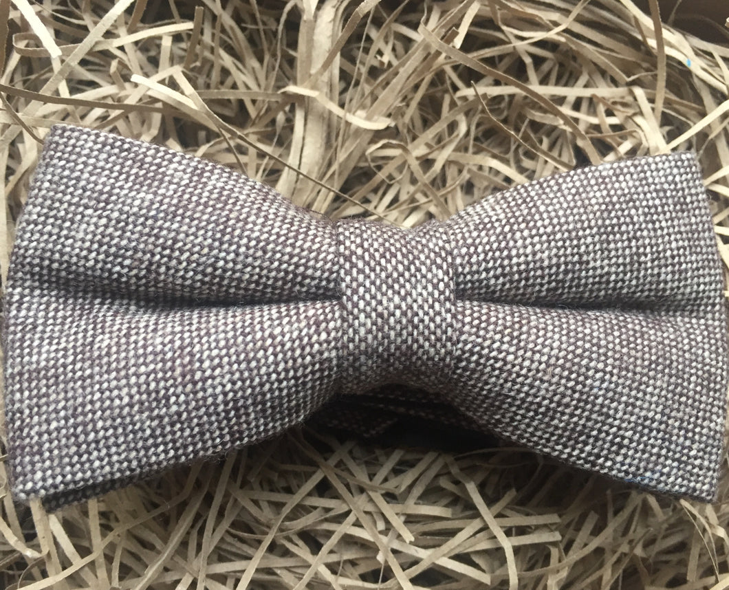 A light brown herringbone tweed bow tie for men. This is a beautiful gift for a men for Christmas or for a groom and his groomsmen at a wedding.