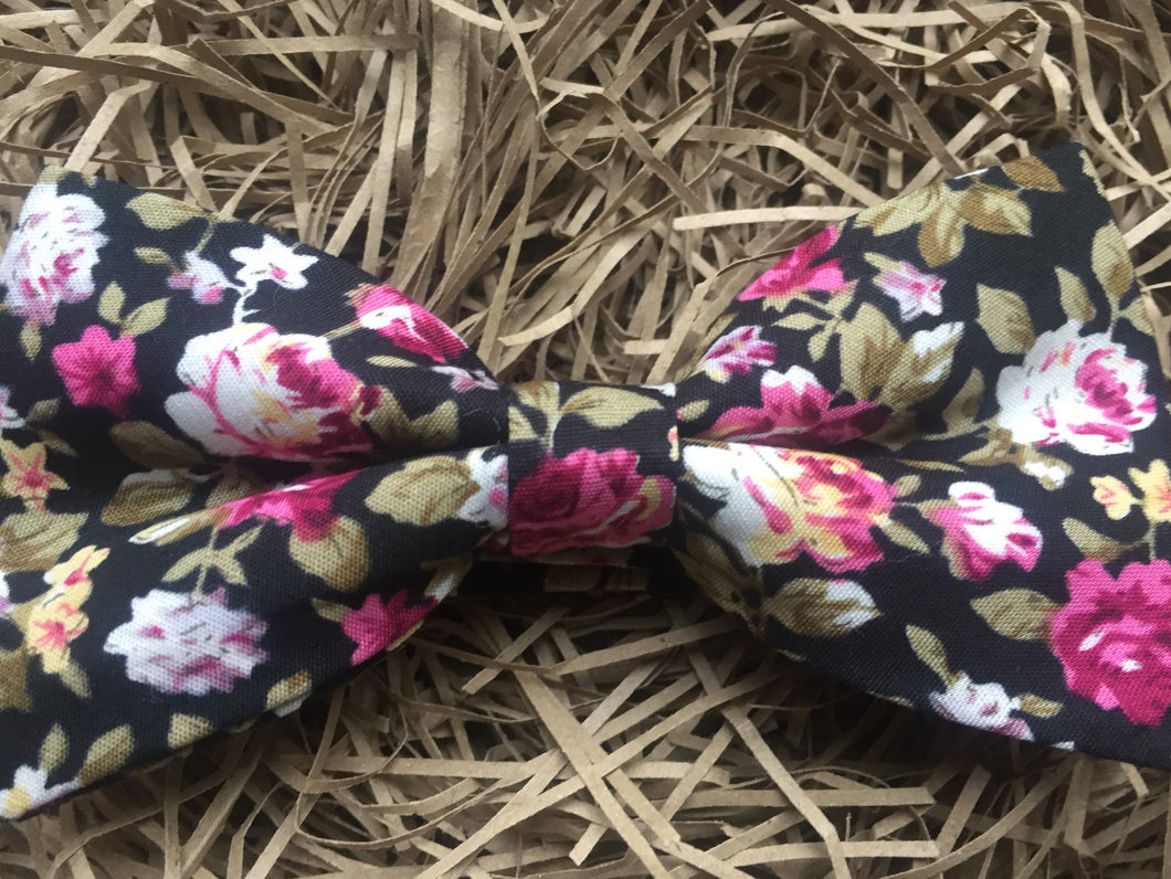 A Daisy and Oak black and pink floral cotton bow tie. Gift wrapped and perfect as a man's gift or wedding bow tie.