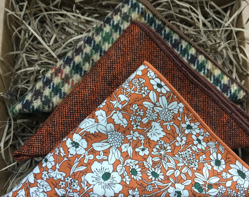 A set of three pocket squares for men. The handkerchiefs are made of wool and in a burnt orange colour and a houndstooth check pattern in green and brow. THe pocket squares come with free gift wapping and make a fabulous men's Christmas gift, secret Santa gift or groomsmen's gifts. 