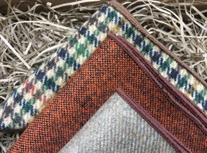 A close up of a set of three wool pocket squares in burnt orange, beige and houndstooth colour. The set comes gift wrapped and is perfect for men's Christmas gifts or groomsmen gifts.