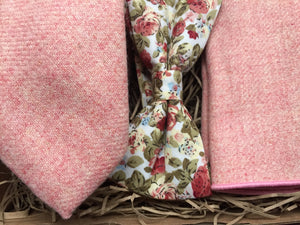 A bespoke blush pink wool tie and pocket square with a pink floral bow tie perfect for weddings or as men's gifts. The set is handmade by Daisy and Oak Studio.