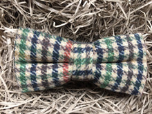 Load image into Gallery viewer, A houndstooth check men&#39;s bow tie in wool. THe checks are in a burnt orange, green, brown and navy colour. The bow tie comes gift wrapped and is perfect as men&#39;s gift or secret Santa. It is also often used as a groomsmen gift or grooms bow tie paired with a tweed suit.