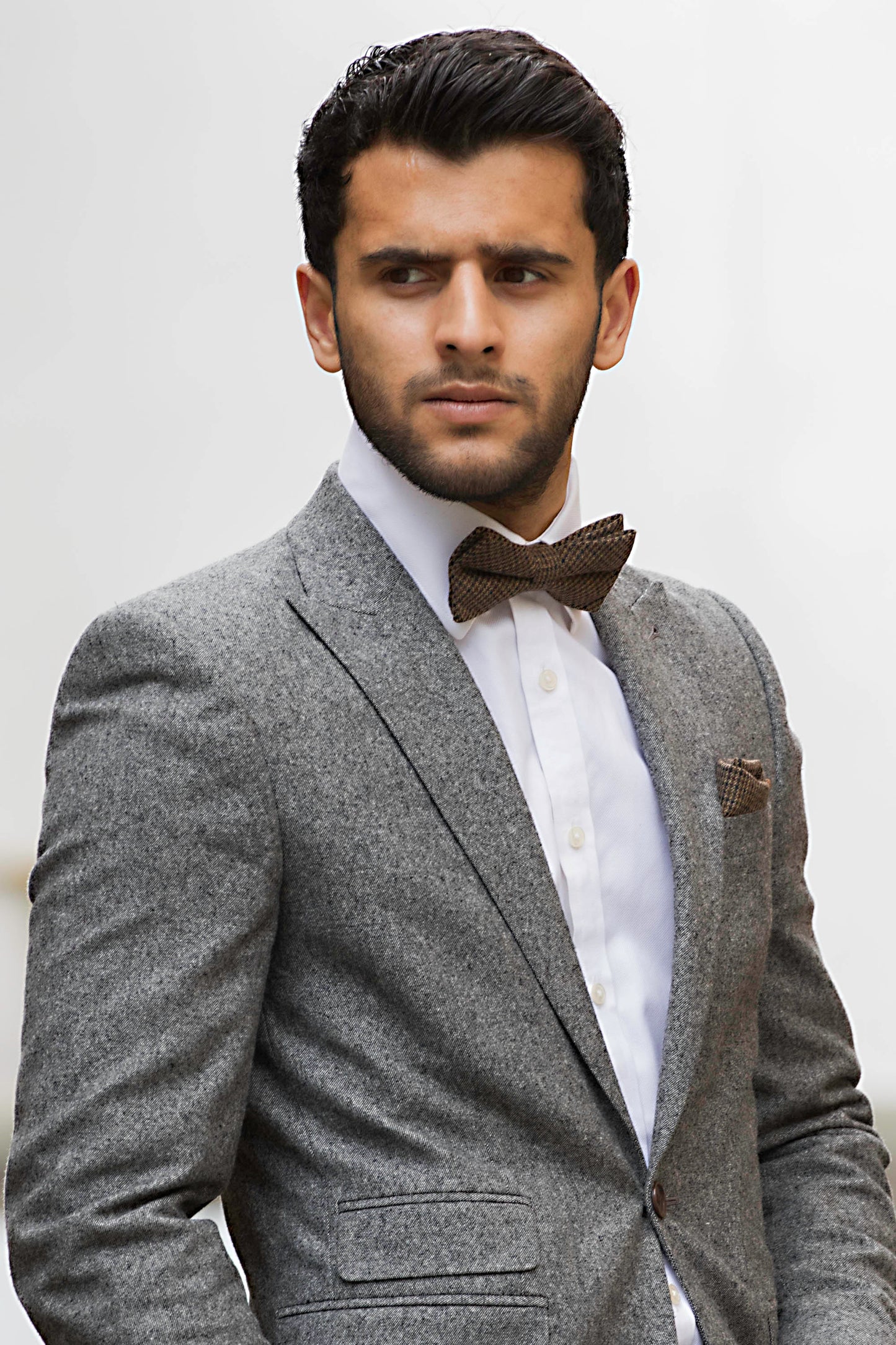 A brown check bow tie in wool matched with a burgundy red wool pocket square. The tie set comes with free gift wrapping and is handmade in the Daisy and Oak Studio, UK
