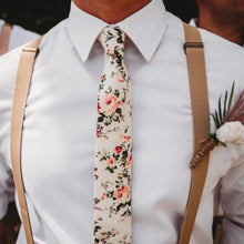 Load image into Gallery viewer, A groom wearing a blush pink floral men&#39;s tie and beige braces. Daisy and Oak Studio makes bespoke men&#39;s ties, bow ties and pocket squares. All of our products are gift wrapped and make perfect men&#39;s gifts at Christmas and birthdays.