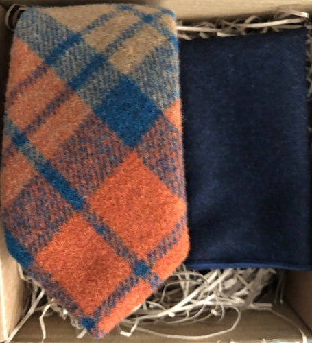  burnt orange rust men's wool tie and navy pocket square handkerchief. THe tie is checked and is a realy nice tie for formal wear or weddings. It works perfectly as a stunning men's gift and comes with free gift wrapping from Daisy and Oak Studio.
