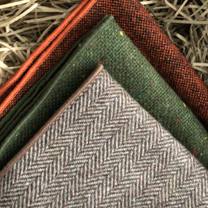 A set of three men's wood pocket square handkerchiefs in rust, burnt orange, brown herringbone and moss green. The set comes with free gift wrapping and is an ideal men's gift, groomsmen gift or to be used as wedding attire.