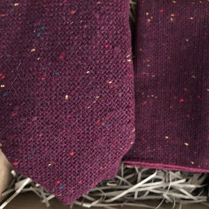 A close up photo of a burgundy flecked wool men's necktie and pocket square. The set comes gift wrapped and makes the best men's Christmas gift, grooms gift and groomsmen's gift.