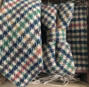 A tie, bow tie and pocket square set in checked wool. The colours in the set are brown, green burnt orange and beige. THe set comes gift wrapped and so is perfect as a groomsman gift, men's Christmas gift or secret Santa.