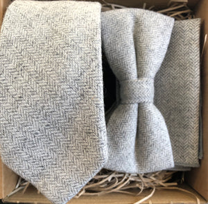 A light grey wool herringbone mens tie bow tie and pocket square set. This is perfect as a mens Christmas gift or secret Santa as it is beautifully gift wrapped. Gift wrapping is free.