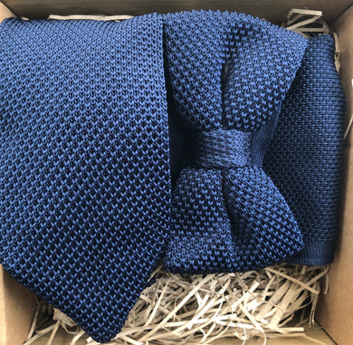 A photo of a navy knitted necktie, bow tie and pocket square. The tie set is perfect wedding attire or as a man's gift and comes with free gift wrapping. Made by Daisy and Oak Studios.