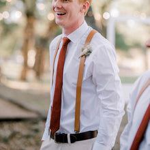 Load image into Gallery viewer, A man at a wedding wearing a burnt orange necktie and braces. The tie comes in rust and terracotta and is perfect as a man&#39;s Christmas gift or as a wedding tie for the groom and groomsmen.