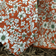 Load image into Gallery viewer, A photo of an orange floral tie and pocket quare made in cotton. The tie has hints of green and is handmade by Daisy and Oak Studio. The tie set comes gift wrapped and is ideal as a mens gift.