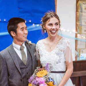 A groom wearing a sage green men's tie, bow tie and pocket square made in cotton and ideal as a wedding tie. The ties are handmade by Daisy and Oak Studio and come with free shipping and gift wrap so making an ideal groomsmen gift or mens gift.