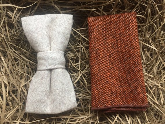 A cream wool bow tie and a burnt orange wool pocket square. The set comes gift wrapped and is idea formal wear with a navy suit. The set is handmade in at the Daisy and Oak Studio, UK.