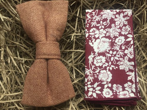 A camel brown men's bow tie and floral pocket square. The floral pocket square is red with white flowers and together they make a perfect men's gift or wedding bow tie set.