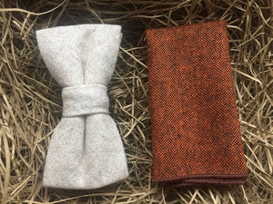 A cream wool bow tie and a burnt orange wool pocket square. The set comes gift wrapped and is idea formal wear with a navy suit. The set is handmade in at the Daisy and Oak Studio, UK.