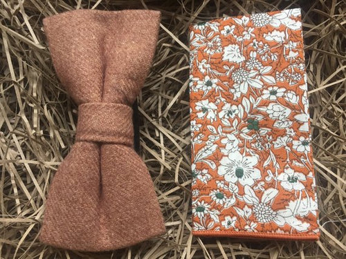 A camel brown bow tie and orange floral pocket square. The bow tie is made of wool and is pre-tied. The pocket square is cotton and has a white floral pattern on an orange background which works perfectly with the camel bow tie. All of our ties and pocket square are gift wrapped and make perfect mens Christmas gifts, secret Santa gifts and groomsmen gifts.