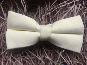 A yellow cotton bow tie and orange pocket square. This highly original set comes with gift wrapping and is made at the Daisy and Oak Studio.